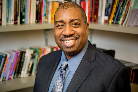 Portrait photograph of Prof. Travis Dixon in office setting