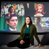 Mustafaj sits in front of a screen displaying films used in her study