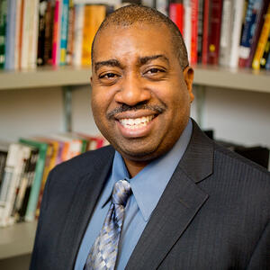 Portrait photograph of Prof. Travis Dixon in office setting